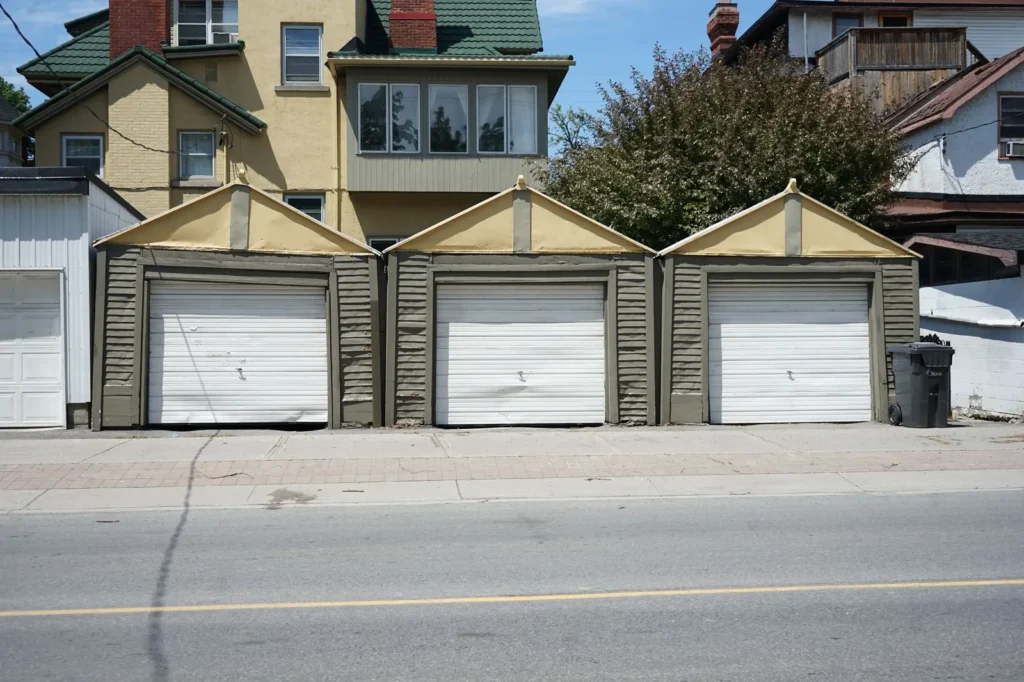 Row of residential garage doors on a sunny street