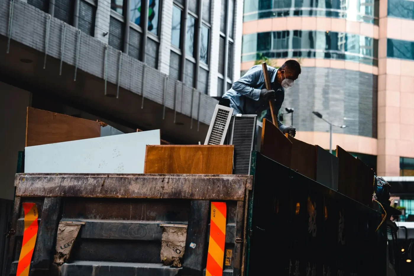 Worker loading debris onto a hauling truck
