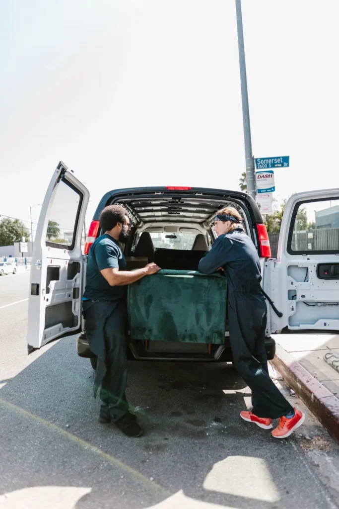 Crew loading furniture into a van
