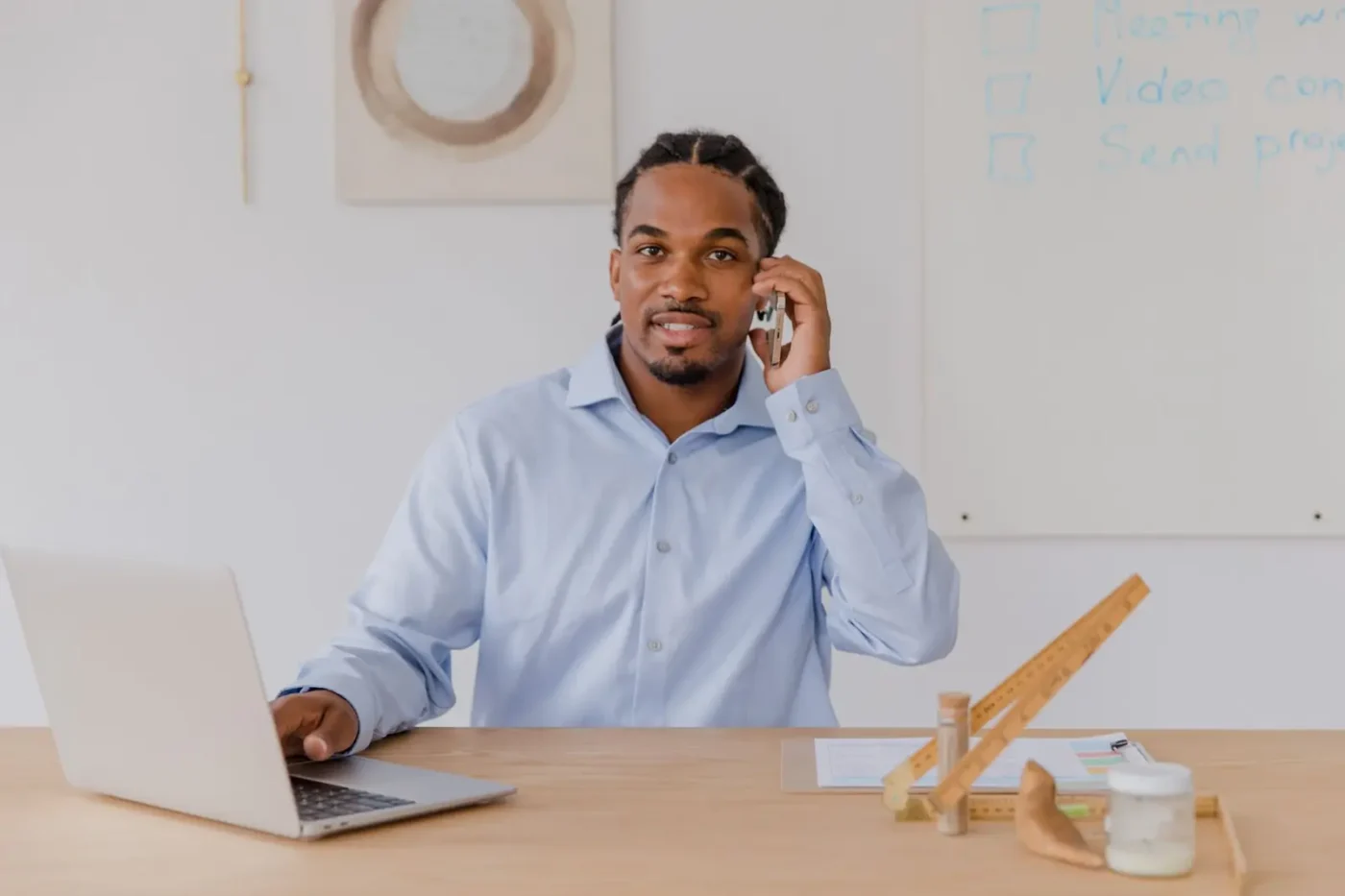 Business owner on a phone call while working on a laptop