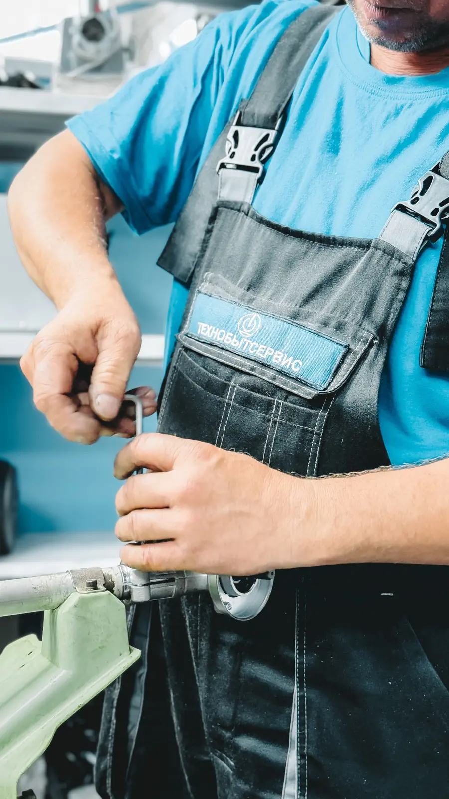 Plumber tightening a pipe fitting with a wrench
