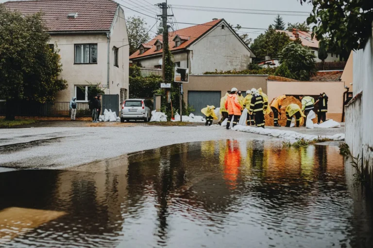 Emergency crew working on a flooded residential street