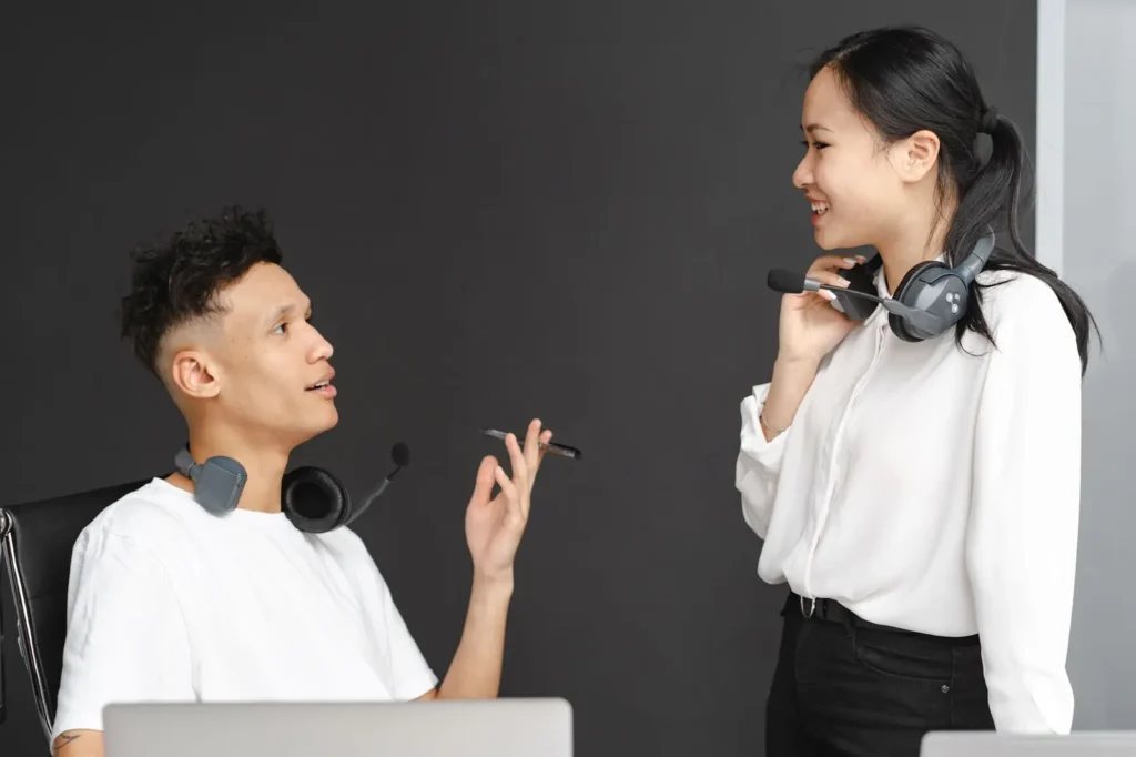Team members with headsets chatting in the office