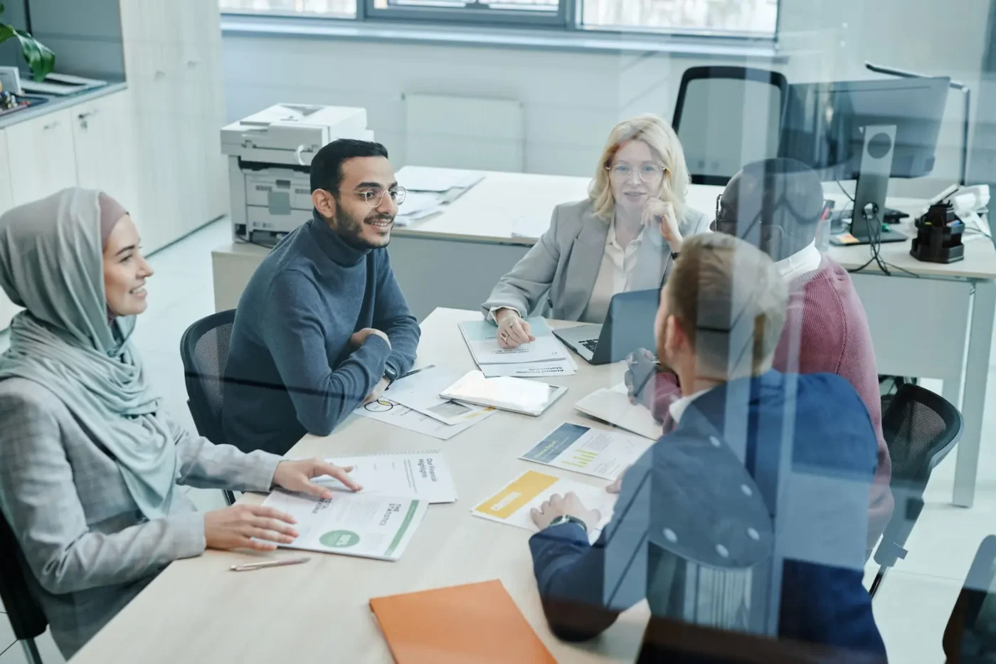 Marketing team talking through a plan around a conference table
