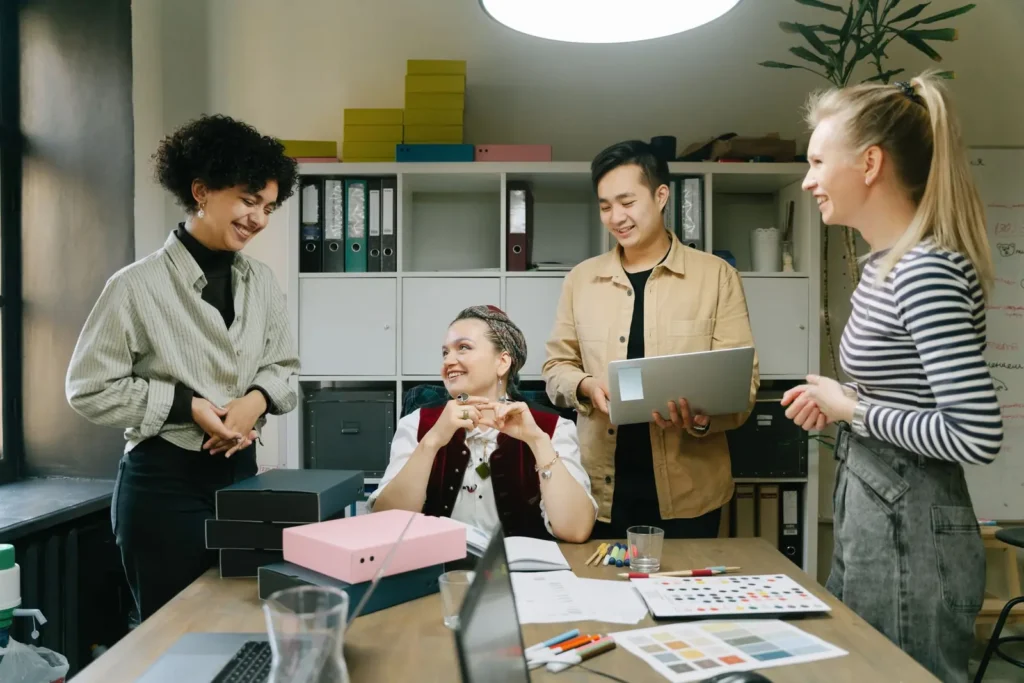 Colleagues reviewing work together in a bright office